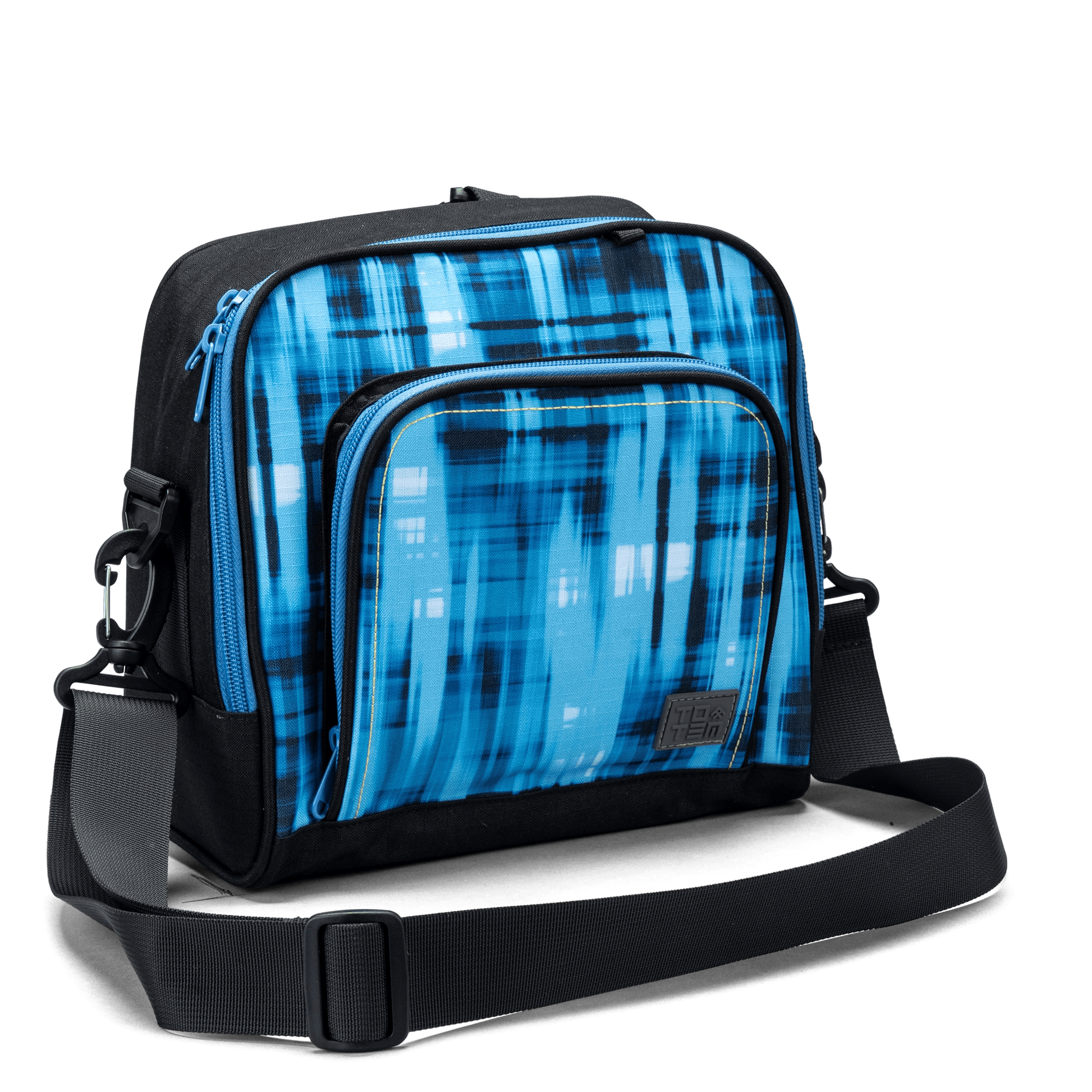 The front zip pocket on a blue geometric Totem lunch bag with contrast yellow stitching and logo patch.
