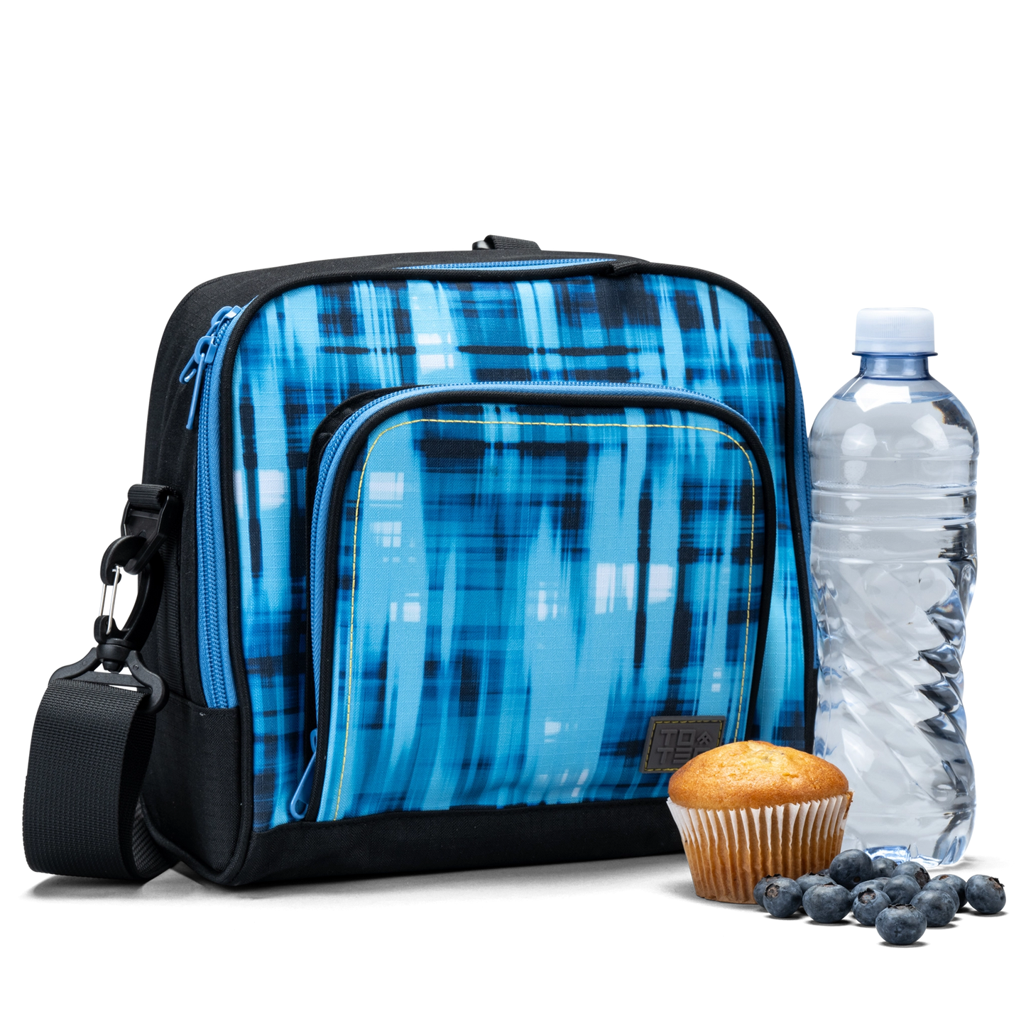 The front pocket on the blue geometric Totem lunch bag has a water bottle and a muffin.