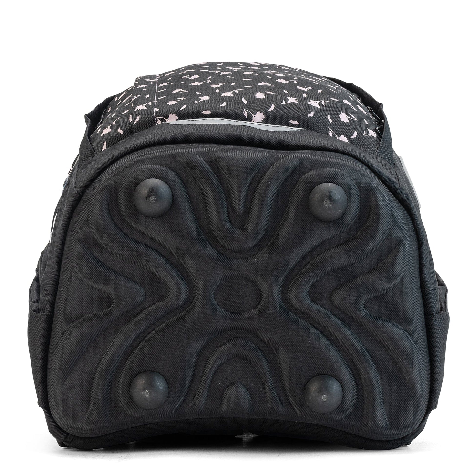 A close-up of a black school bag base with four protective feet and a textured, reinforced surface.