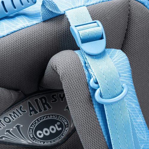 A close-up of a light blue Totem school backpack showing a padded ergonomic shoulder strap and a D-ring attachment.