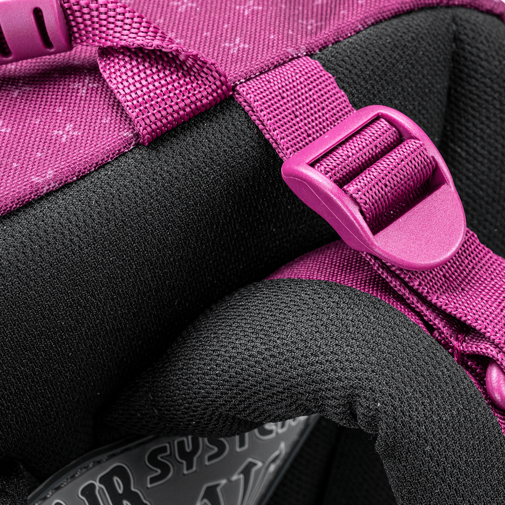 A close-up of the purple school backpack padded strap and adjustment buckle against the black ergonomic back panel.
