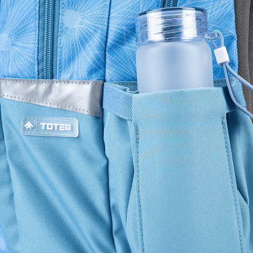 Close-up view of an ergonomic Totem school bag showing an elastic side water bottle pocket with a frosted bottle and logo detail.