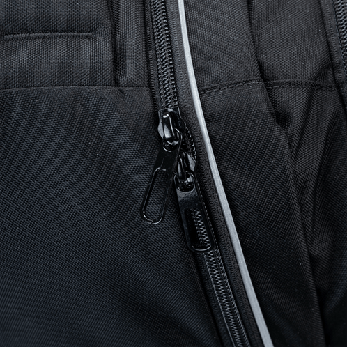 A close up of zips found on a black school trolley bag with wheels.