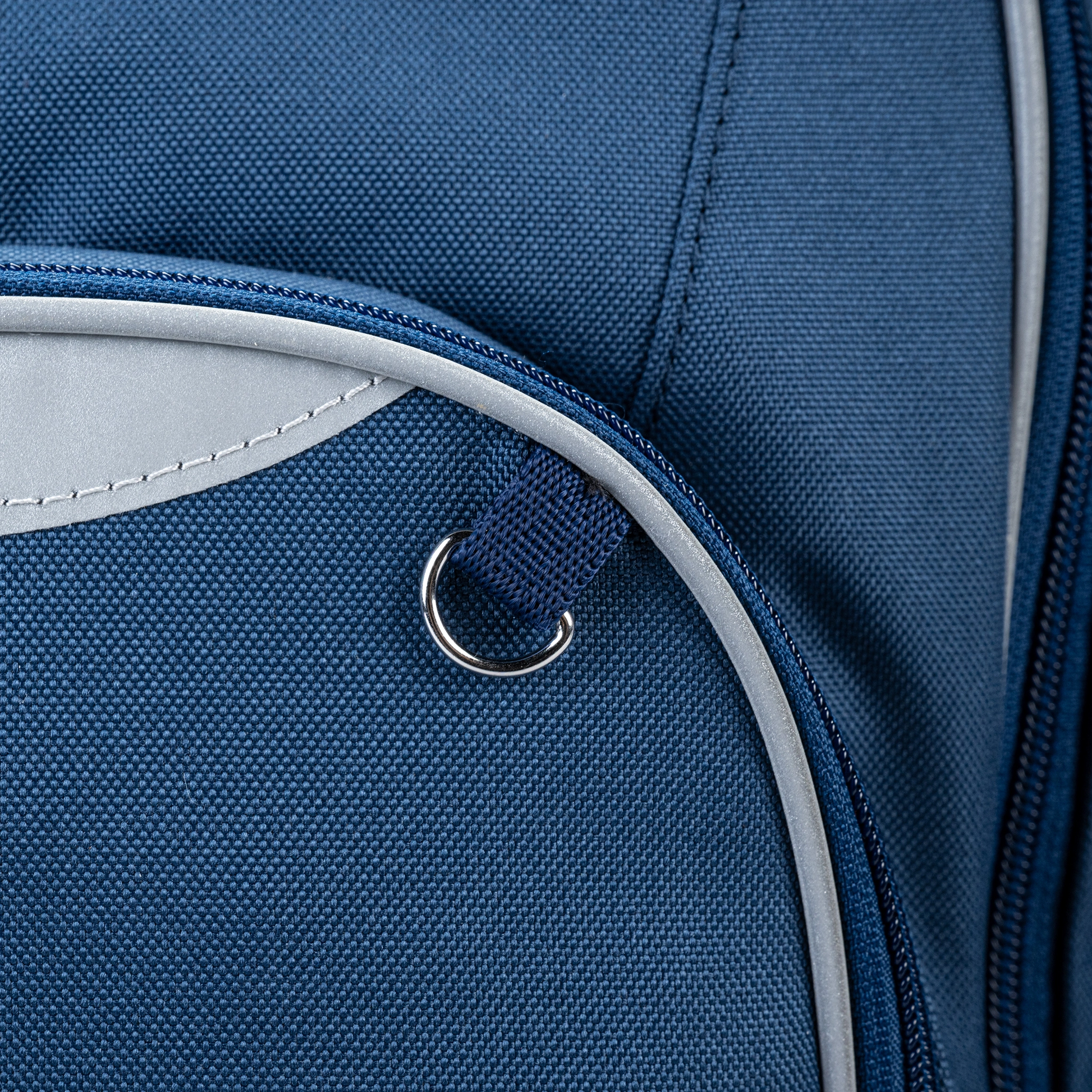 A close up of a Navy trolley bag with wheels and a handle that also has shoulder holders so that you can carry it on your back with an attachable.