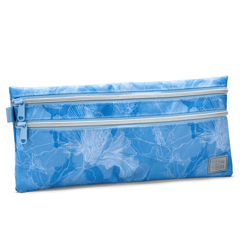 Angled view of a blue Totem pencil case with double zippers and a floral outline design, shown against a black background.