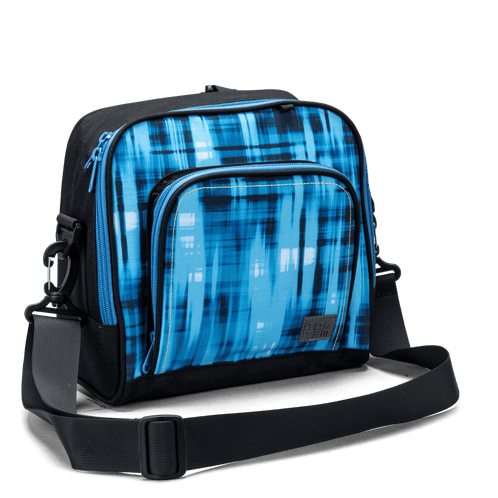 The front zip pocket on a blue geometric Totem lunch bag with contrast yellow stitching and logo patch.