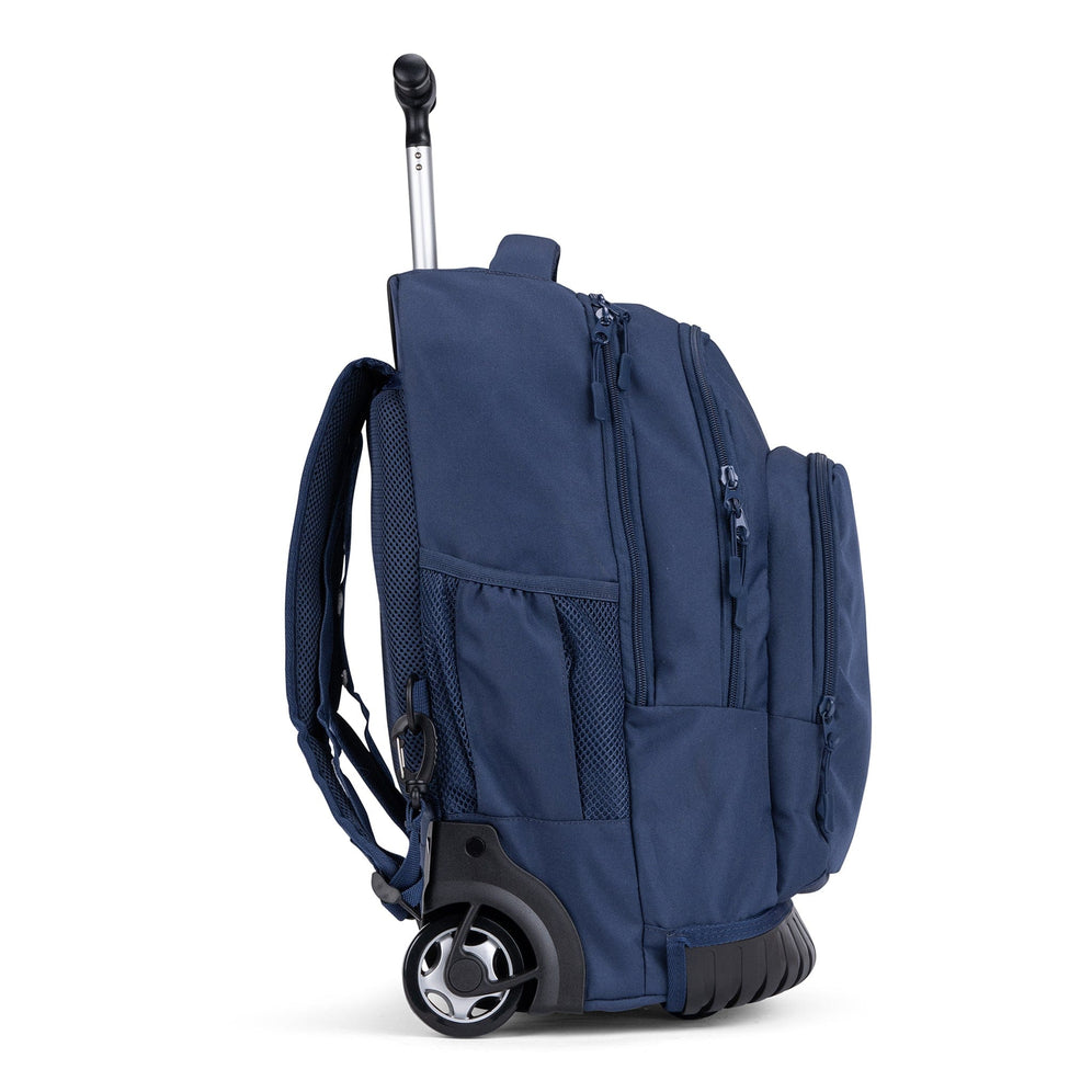 The side view of a navy Savvy trolley backpack with mesh pockets, zip compartments and sturdy wheels.