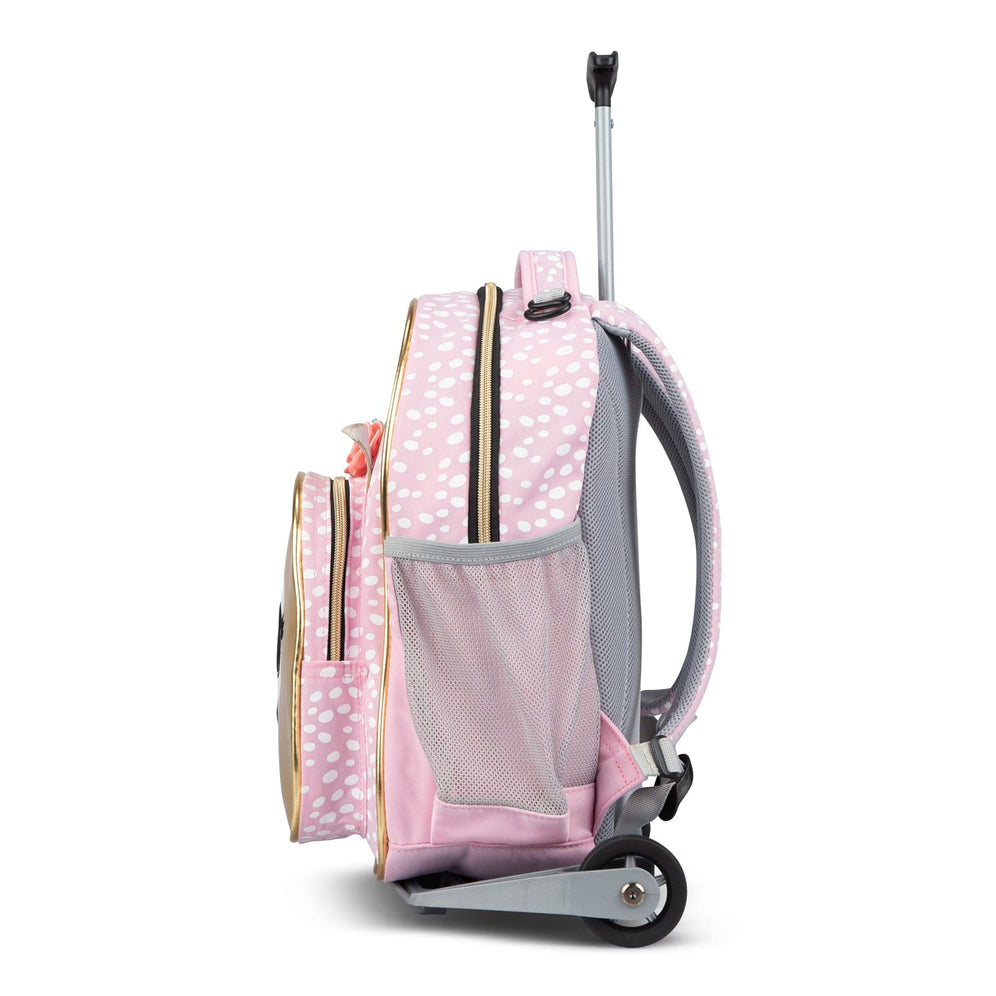 The side view of a pink polka-dot Totem trolley school bag with a mesh pocket, wheels and an extended handle.