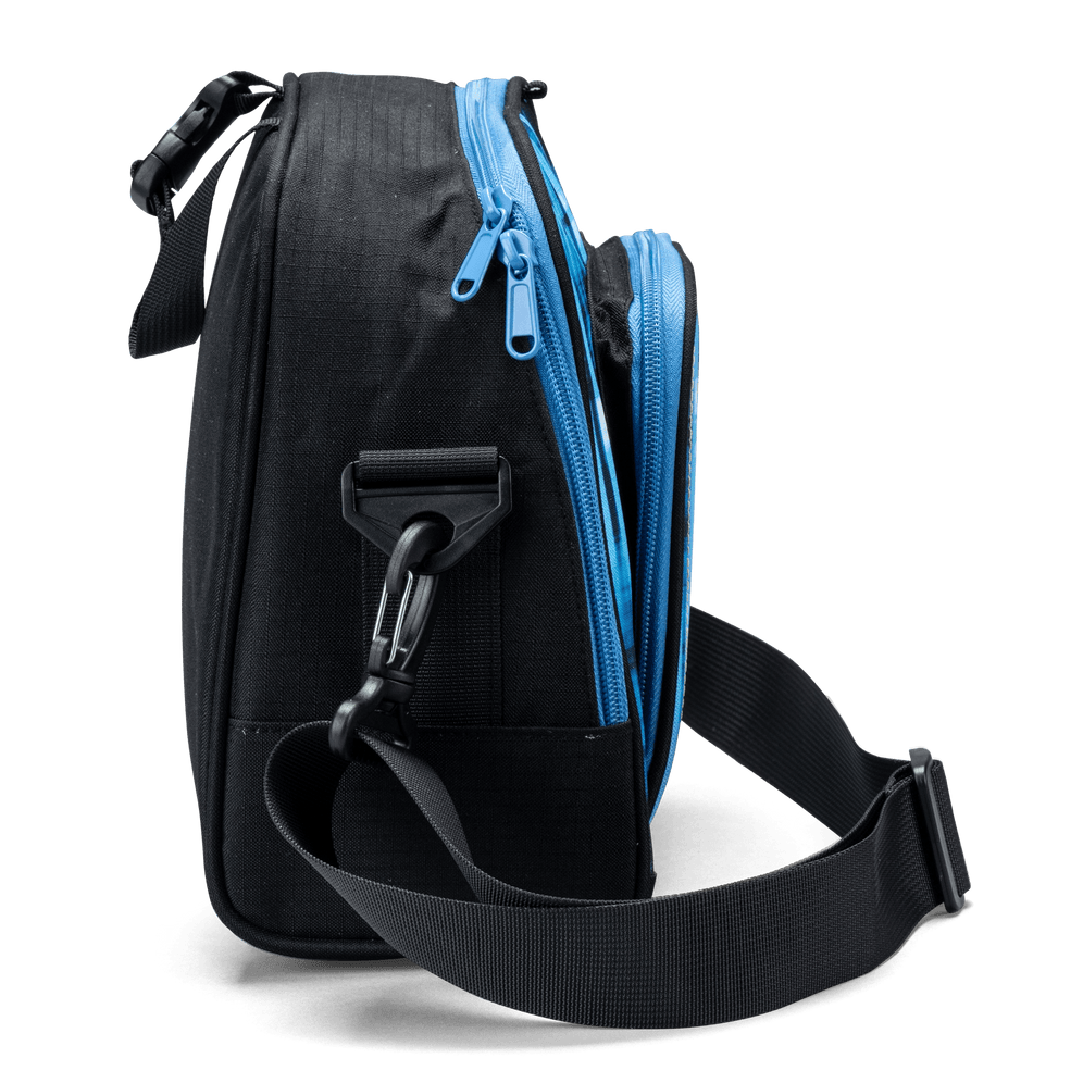 The side profile of a black Totem lunch bag with blue zip detailing and a detachable shoulder-strap clip.