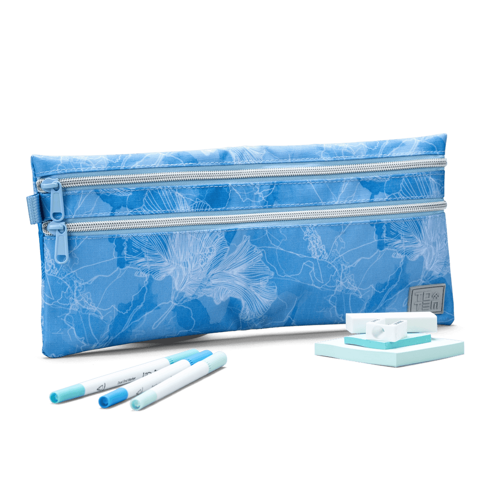 A blue Totem double-zip pencil case with a floral line pattern, displayed with markers, erasers, and sticky notes.