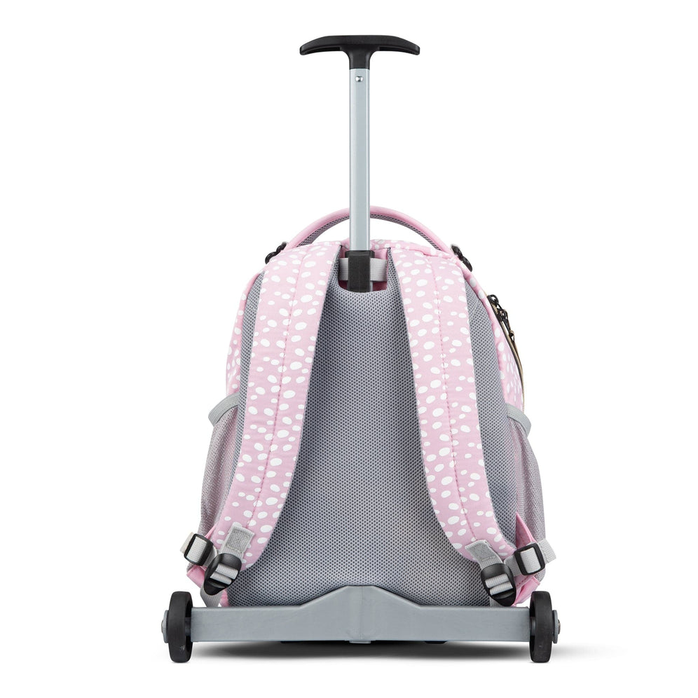 The back view of a pink polka-dot Totem trolley backpack with padded straps and a telescopic handle extended.