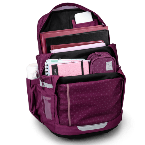 Open view of the berry-purple Totem school bag packed with books, notebooks, stationery and a water bottle in the side pocket.