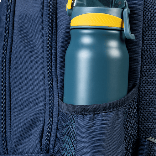 A close-up of a water bottle inside the navy backpack mesh side pocket.