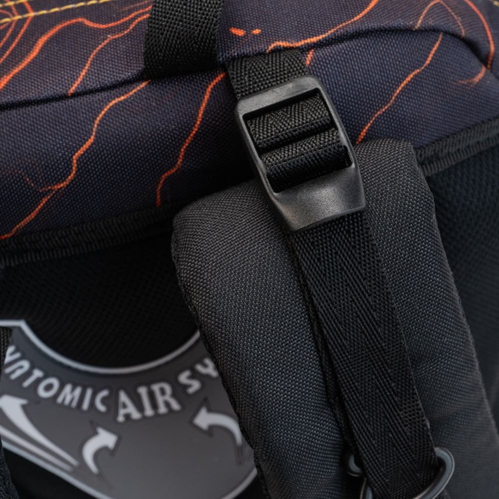A close-up of a black strap adjuster against charcoal fabric with orange streaks on a Savvy School bag.