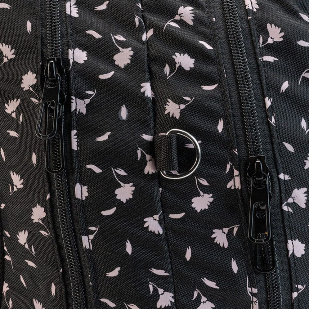 A close-up of a black Totem school bag side pocket holding a white insulated bottle.