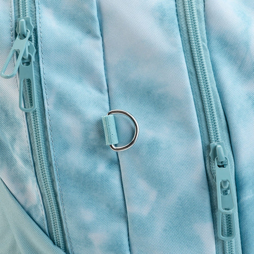 A close-up view of the turquoise tie-dye school backpacks zips and metal D-ring, an attachment point for small accessories.