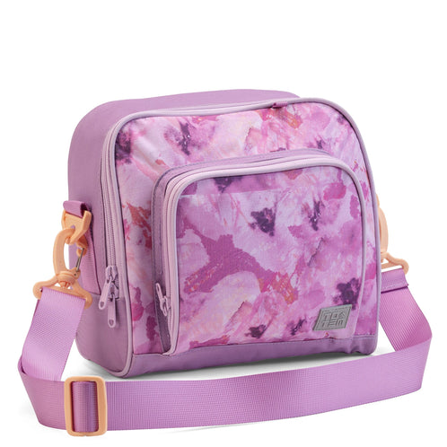 The front three-quarter view of the lilac Totem lunch bag with a pink watercolour design and an adjustable shoulder strap.