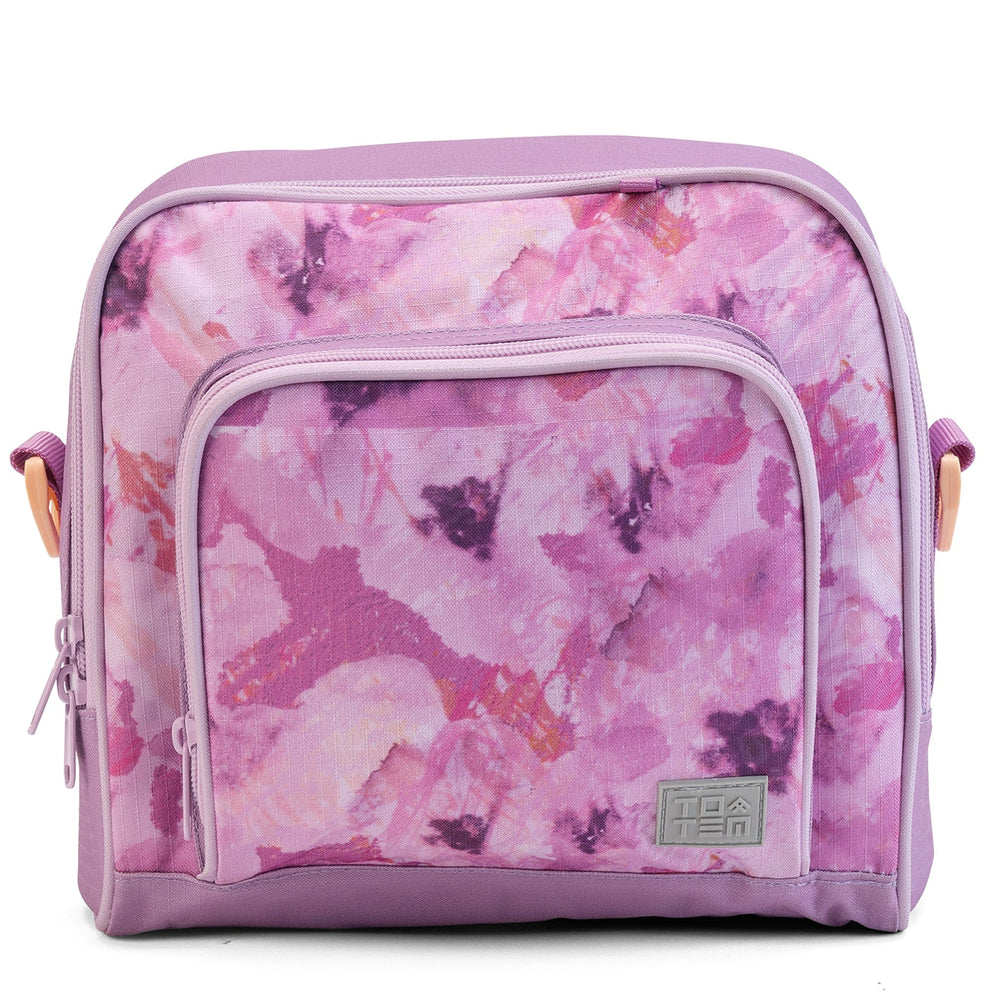 A front view of a lilac Totem insulated lunch bag with a pink and purple watercolour print and a front zip pocket.