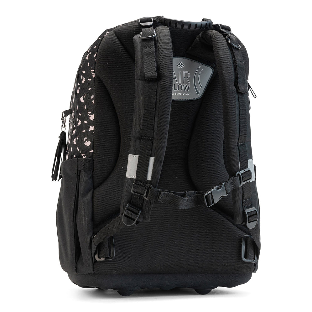 A rear view of a black floral school bag featuring padded shoulder straps and a sternum strap.