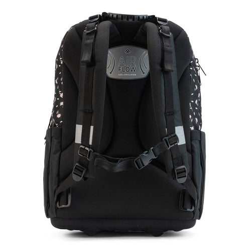 The back view of a black floral school bag with padded straps, airflow panel, and adjustable chest buckle.