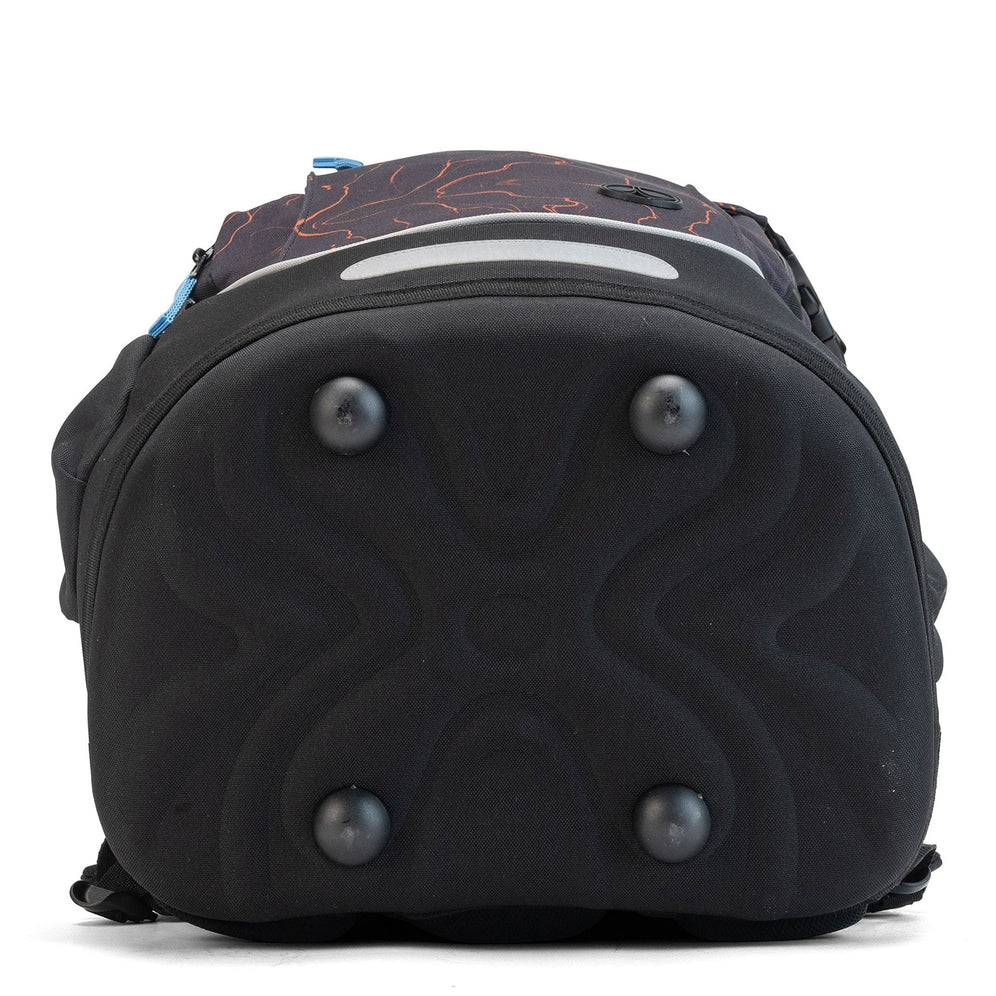 A black moulded base with four protective feet and a grey reflector on a School backpack.